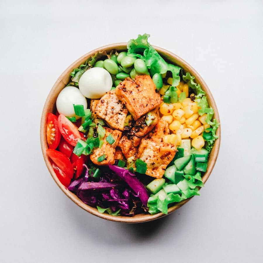 A fresh grain bowl with greens on a wooden table